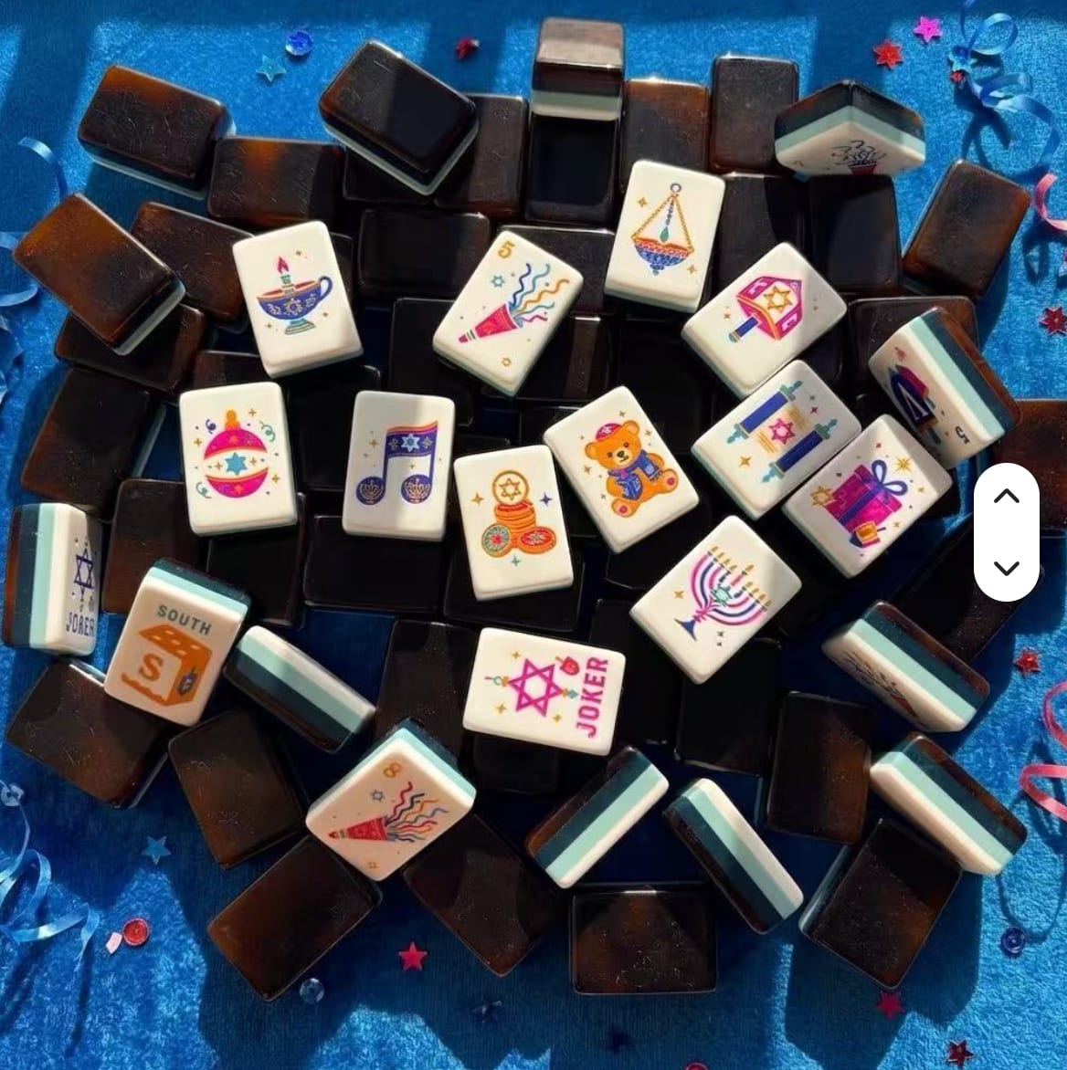 Festival Celebration tiles in a pile — ivory faces, teal multi-layer sides, dark backs